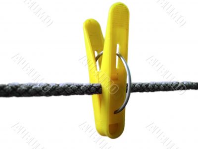 Yellow clothes peg and string on the white background isolated