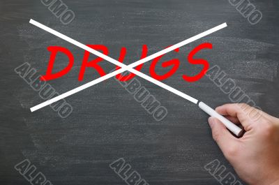 Say no to drugs - crossing out drugs on a smudged chalkboard 
