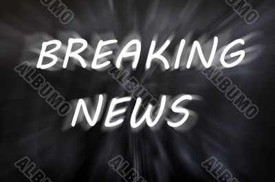 Breaking news written with motion rays on retro blackboard background 