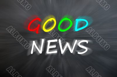 Chalk drawing of `Good news` on blurred chalkboard 