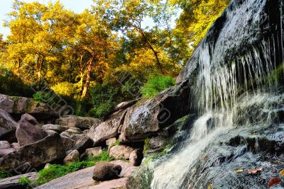 Falls among the rocks and autumn trees