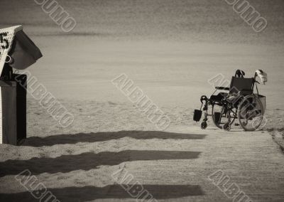 Wheelchair parked on the edge of sand