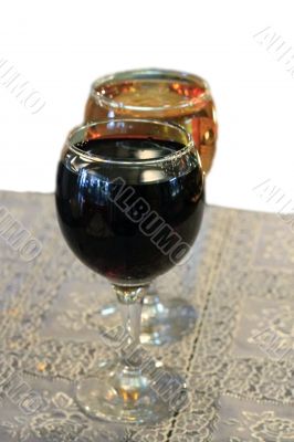 Two glasses on the table with a white tablecloth isolated on the