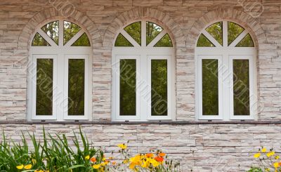 Three windows in the stone wall