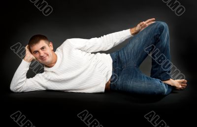 man in a white sweater lying