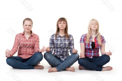 Three girls sitting in lotus posture