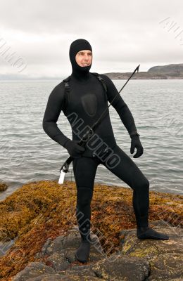Freediver in a diving suit on the Barents Sea