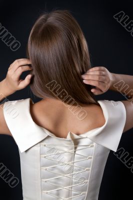 Beautiful slim girl in a wedding dress with a corset back