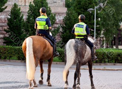 Two girls policeman on a horse