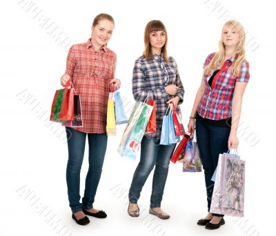 Three girls with colorful shopping bags