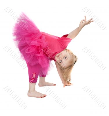 little girl in a pink dress dancing in the studio bow