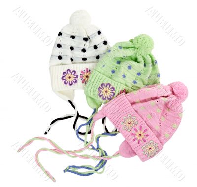 three colored children`s knitted hat with a flower pattern
