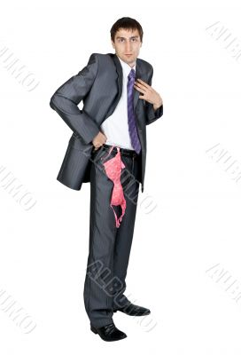 businessman in a gray suit from his pocket a pink bra hanging