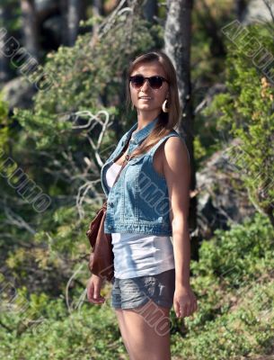 girl in sunglasses in the woods