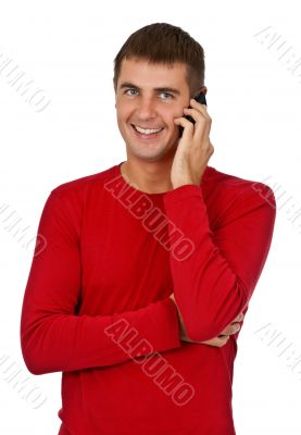 man in a red dress speaks on a mobile phone.