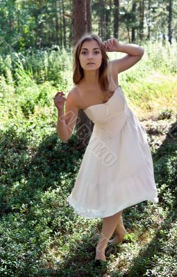 girl in a cream dress in a forest