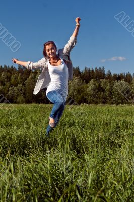 girl runs across the green grass