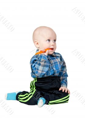 A small child with an orange spoon