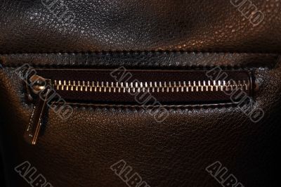 Zipper on dark brown leather hand bag