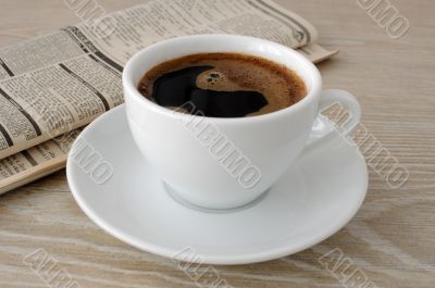 A cup of coffee and a newspaper