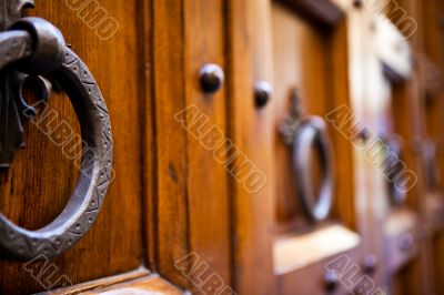 Metal clapper on ancient wooden door