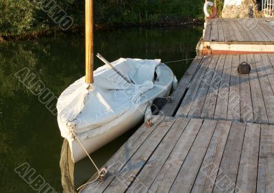 Lonely boat by a lonely pier