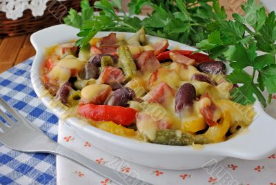 Beans with ham and vegetables, baked with cheese