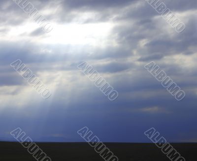 Dramatic sky and rays falling through the clouds