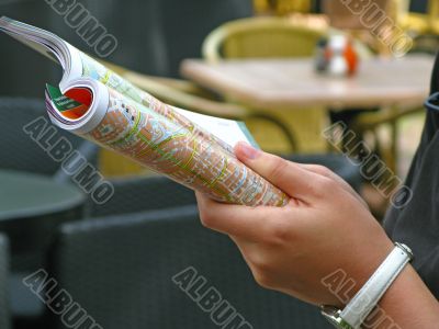 Female hand holding a map Female hand holding a map