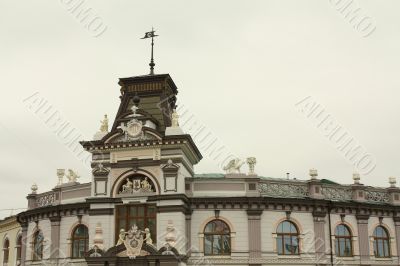 The facade of the building with a sculpture