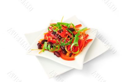 A salad of tomatoes, sweet peppers, red beans, carrots with sesa