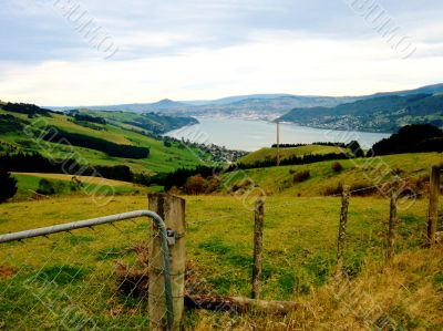 Fence, Fields, Lake And Houses Fence, Fields, Lake And Houses