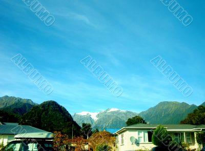 Blue Sky Above Mountains And Houses 