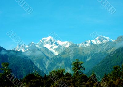 Mountains And Clouds Above Forests 