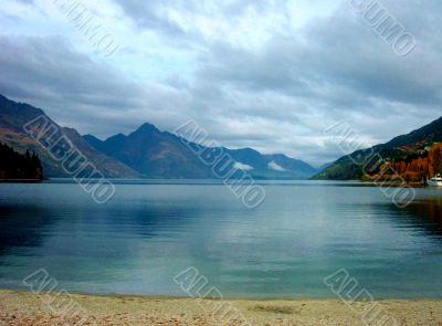 Perfectly Still Lake By Mountains 