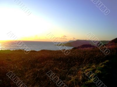 Sunset Over Farmland And Ocean