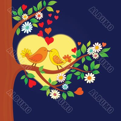 Two kissing birds on the tree