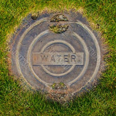 Water Manhole Cover in Grass