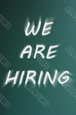 We are hiring - written on a green chalkboard background