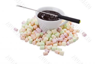 cup of melted chocolate in pile of colorful marshmallow