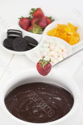 melted chocolate with fruits and cookies