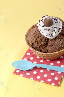 close up image of chocolate ice cream with table napkin and spoon