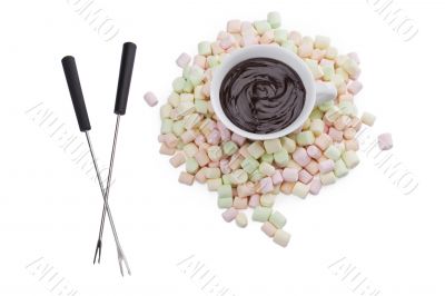 cup of melted chocolate with marshmallows and fondue stick cup of melted chocolate with marshmallows and fondue stick