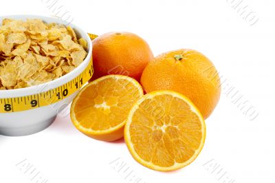 cropped corn flakes bowl and orange fruit