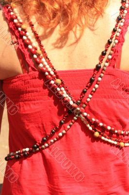 Women`s beads on the red background