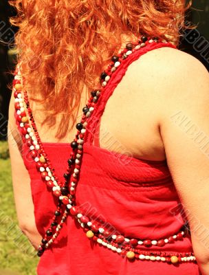 Women`s beads on the red background