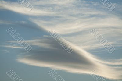 Diagonal clouds on blue sky