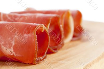 ham rolled in a wooden board