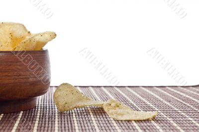 crispy sour cream and onion potato chips in wooden bowl
