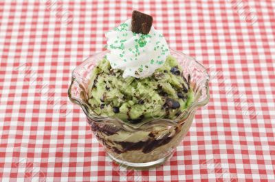 a bowl of pistachio ice cream with chocolates